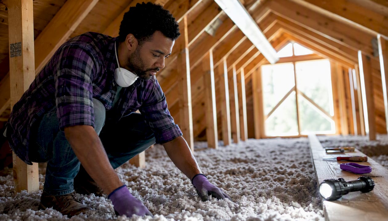 Contractor installing attic insulation in Chicagoland home