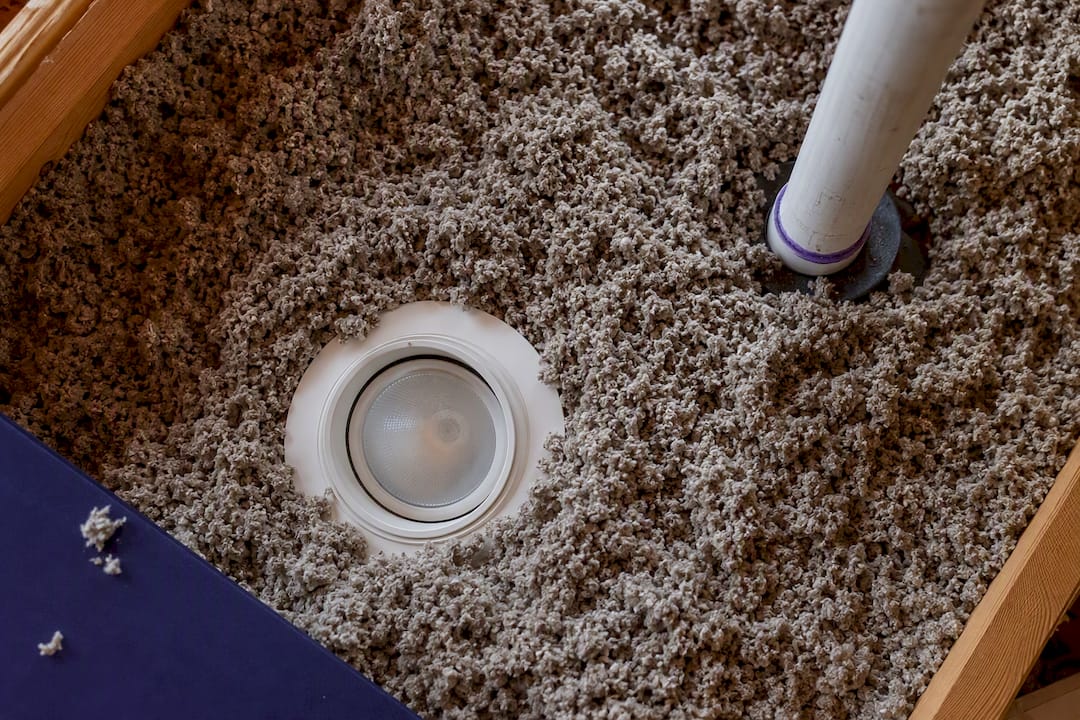 Uneven blown-in insulation around attic obstacles