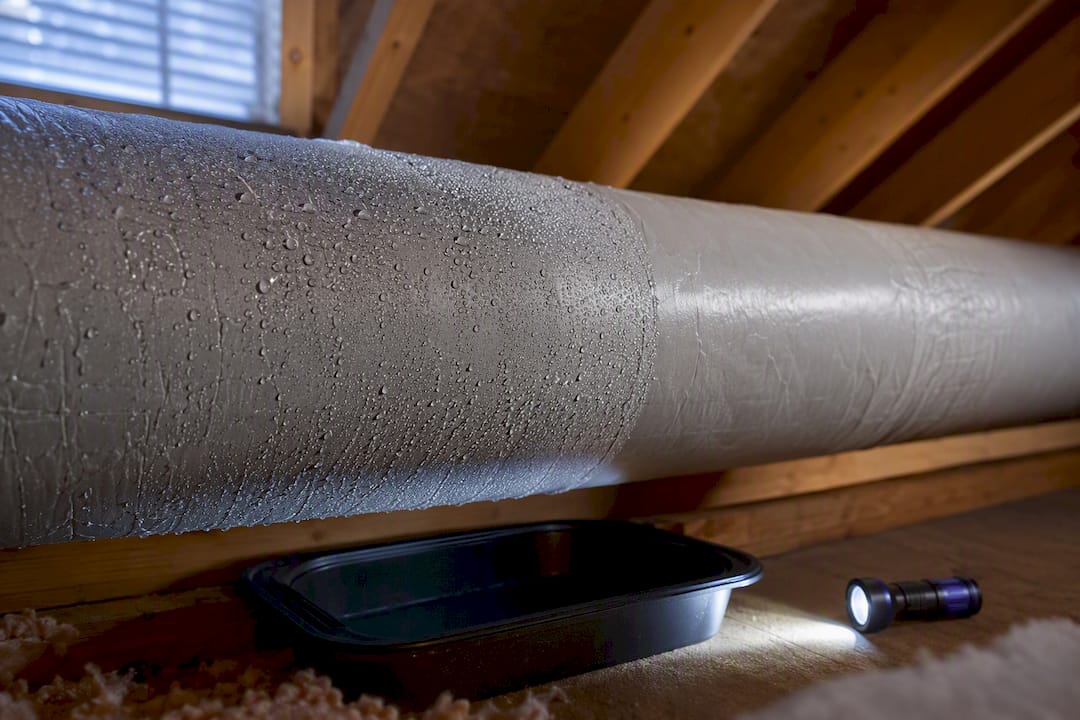 Condensation beads on an attic HVAC duct