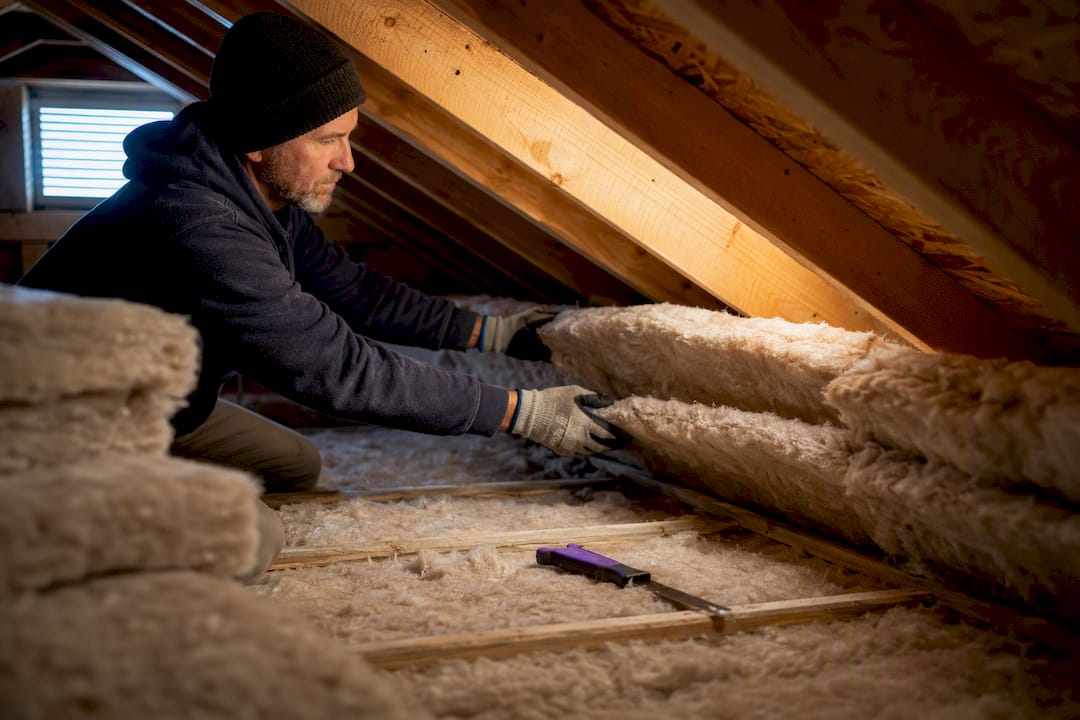 Attic insulation installed along roof eaves
