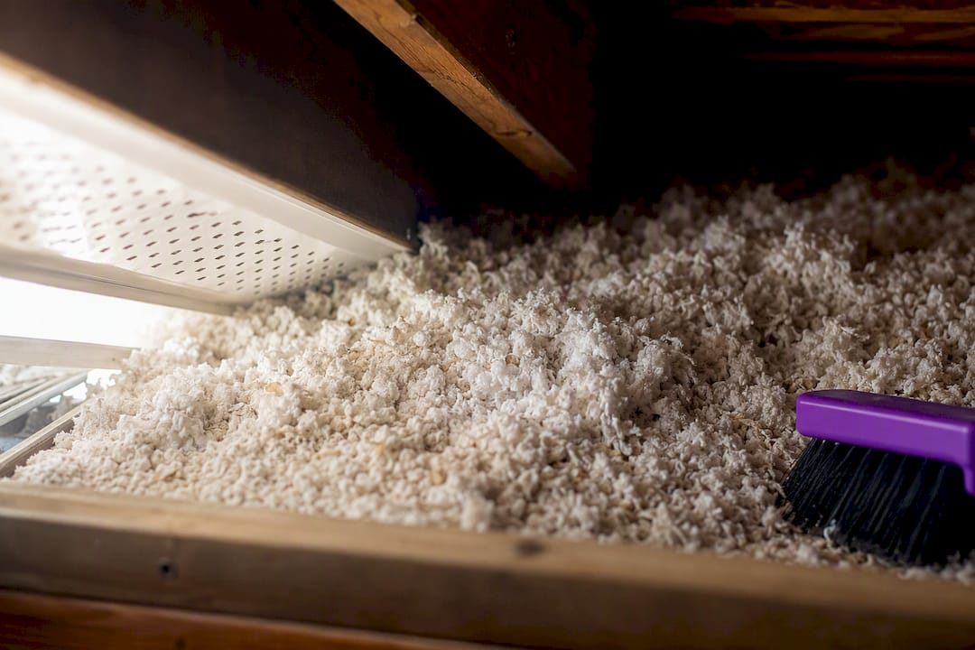 Loose insulation covering soffit vent